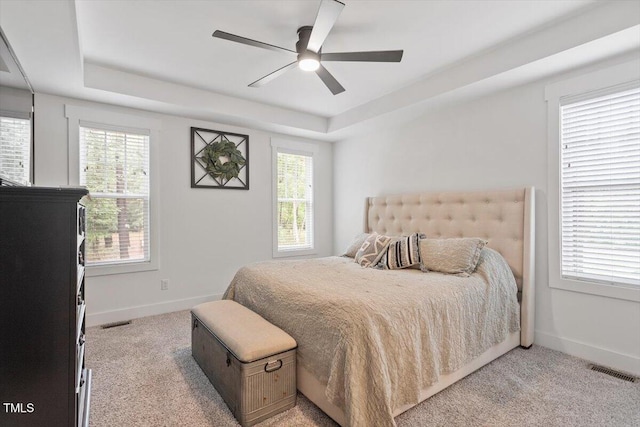 210 Sorrel Dr, Franklinton, NC 27525 - bedroom featuring light carpet, baseboards, a tray ceiling, and ceiling fan