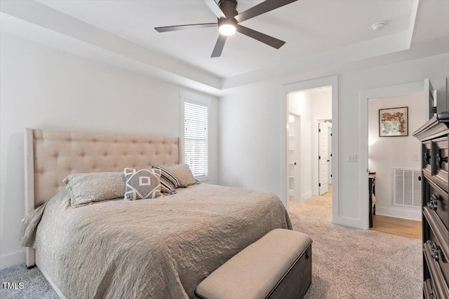 210 Sorrel Dr, Franklinton, NC 27525 - bedroom featuring light carpet, a tray ceiling, ensuite bath, and baseboards
