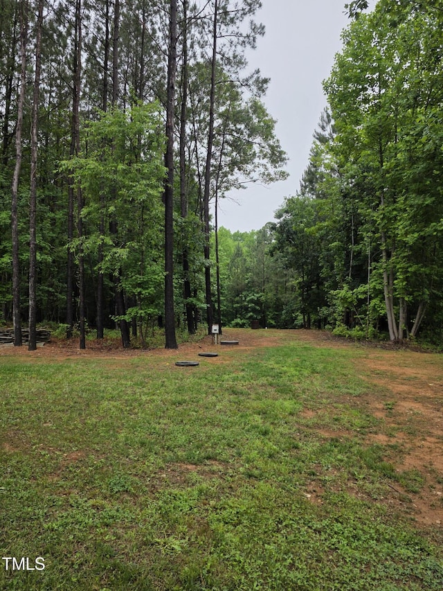 210 Sorrel Dr, Franklinton, NC 27525 - view of green lawn with a wooded view