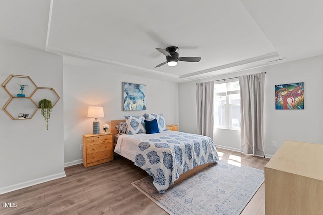 6415 Mentor Pl, Raleigh, NC 27616 - bedroom with a raised ceiling, baseboards, light wood-style floors, and ceiling fan