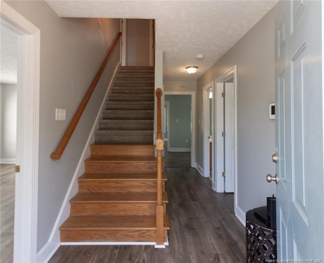 526 E Stack St, Saint Pauls, NC 28384 - stairway featuring baseboards, wood finished floors, and a textured ceiling