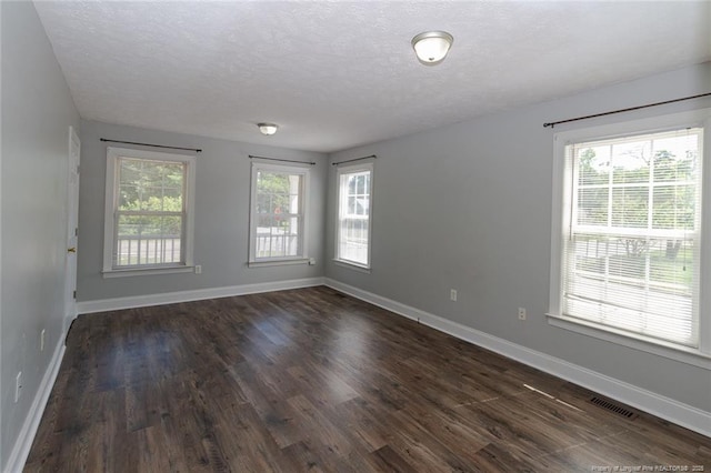 526 E Stack St, Saint Pauls, NC 28384 - empty room featuring dark wood-style floors, baseboards, and a textured ceiling