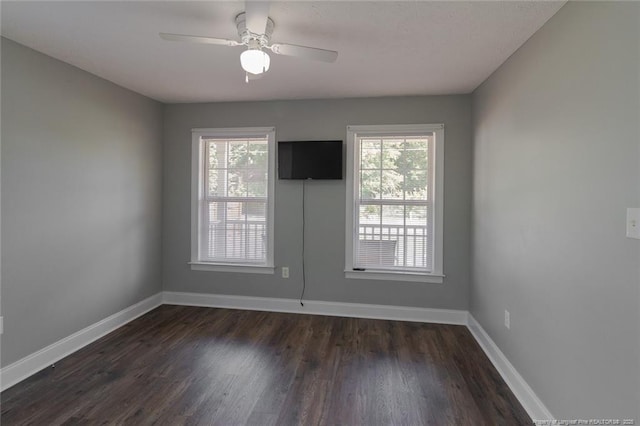 526 E Stack St, Saint Pauls, NC 28384 - spare room featuring plenty of natural light, baseboards, and dark wood-style flooring