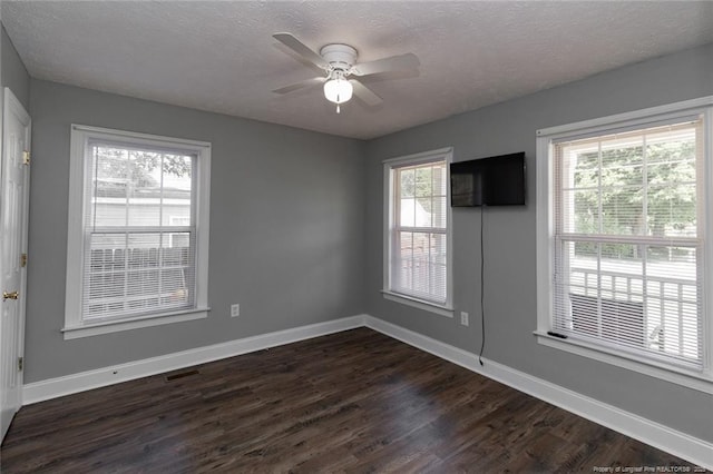 526 E Stack St, Saint Pauls, NC 28384 - spare room featuring a textured ceiling, dark wood finished floors, ceiling fan, and baseboards