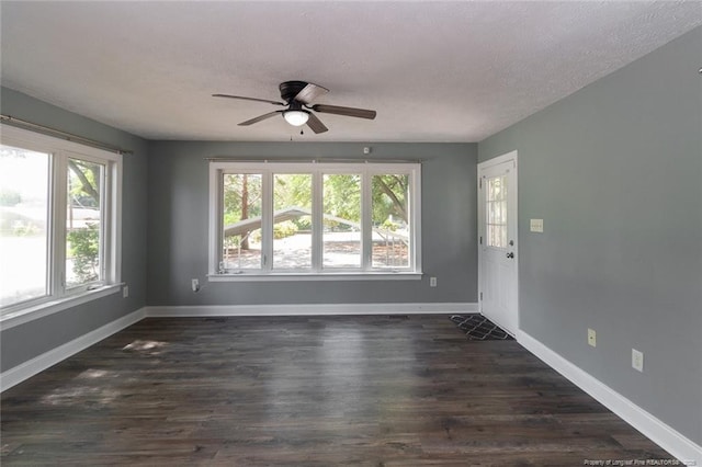 526 E Stack St, Saint Pauls, NC 28384 - empty room featuring a ceiling fan, a textured ceiling, baseboards, and dark wood-type flooring