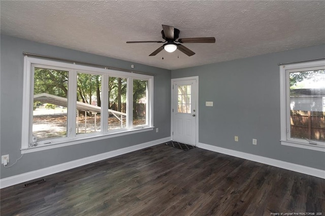 526 E Stack St, Saint Pauls, NC 28384 - foyer entrance with a textured ceiling, dark wood finished floors, a ceiling fan, and baseboards