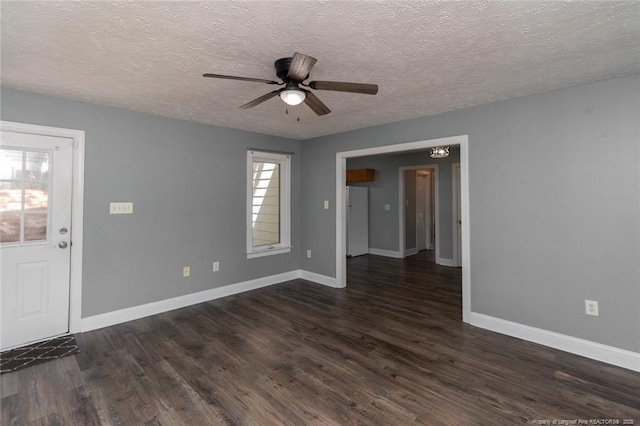 526 E Stack St, Saint Pauls, NC 28384 - spare room with ceiling fan, a textured ceiling, dark wood-style floors, and baseboards