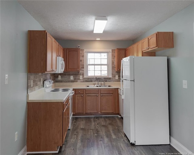 526 E Stack St, Saint Pauls, NC 28384 - kitchen with white appliances, a sink, tasteful backsplash, dark wood-style flooring, and a textured ceiling