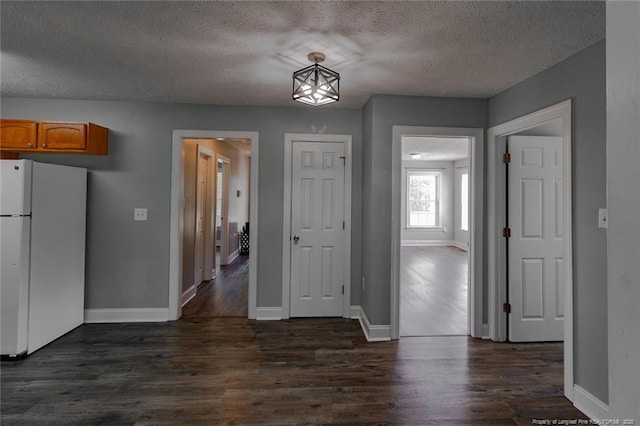 526 E Stack St, Saint Pauls, NC 28384 - unfurnished dining area with a textured ceiling, baseboards, and dark wood-style floors