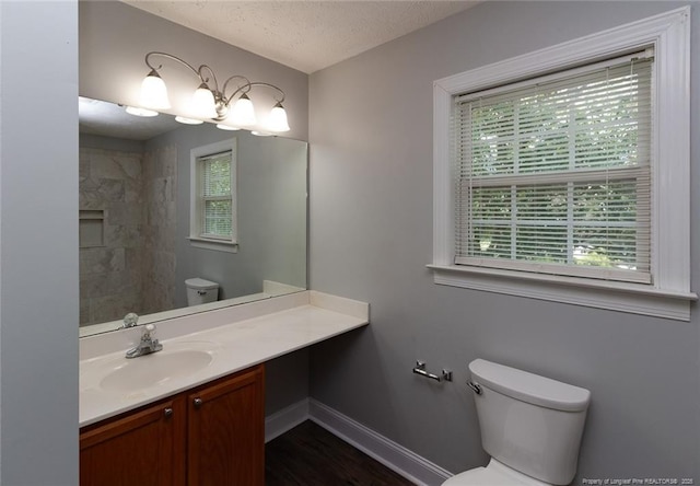 526 E Stack St, Saint Pauls, NC 28384 - bathroom with toilet, plenty of natural light, vanity, baseboards, and a textured ceiling