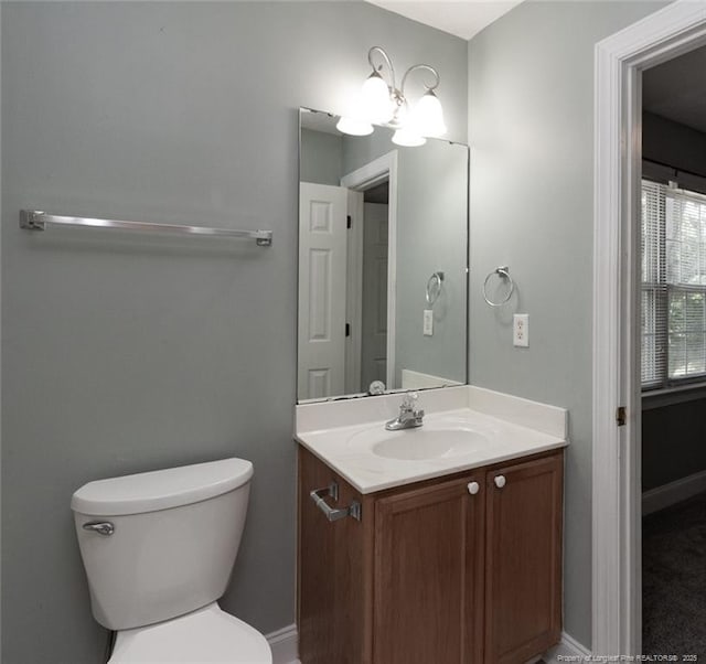 526 E Stack St, Saint Pauls, NC 28384 - bathroom featuring vanity, toilet, and a chandelier