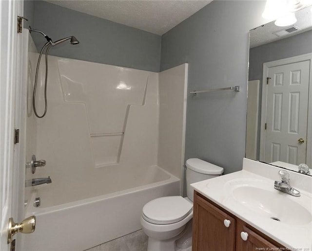 526 E Stack St, Saint Pauls, NC 28384 - bathroom featuring vanity, shower / washtub combination, toilet, tile patterned flooring, and a textured ceiling