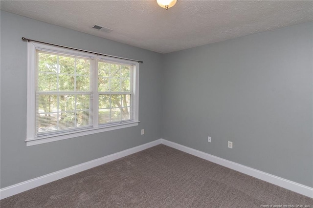 526 E Stack St, Saint Pauls, NC 28384 - empty room with a textured ceiling, baseboards, and dark carpet