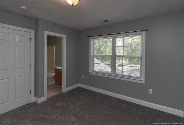 526 E Stack St, Saint Pauls, NC 28384 - unfurnished bedroom featuring carpet flooring, a textured ceiling, baseboards, and connected bathroom
