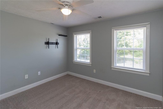 526 E Stack St, Saint Pauls, NC 28384 - unfurnished room featuring baseboards, light colored carpet, ceiling fan, and a textured ceiling