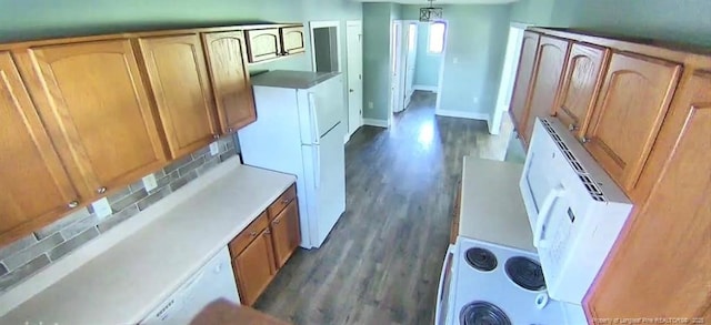 526 E Stack St, Saint Pauls, NC 28384 - kitchen with dark wood-style floors, light countertops, brown cabinets, and decorative light fixtures