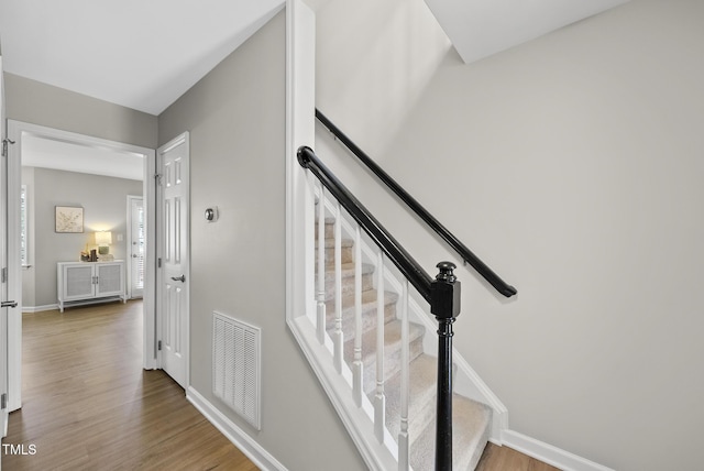 9212 Sayornis Ct, Raleigh, NC 27615 - stairs featuring wood finished floors and baseboards