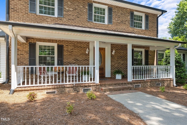 2127 Somers Ave, Burlington, NC 27215 - view of front of home with covered porch, brick siding, and crawl space