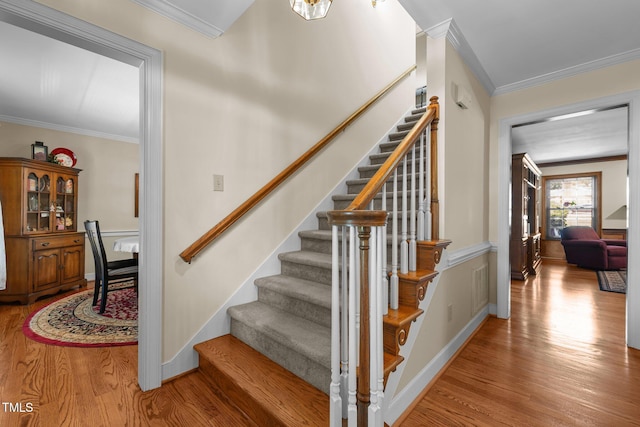 2127 Somers Ave, Burlington, NC 27215 - stairs featuring wood finished floors, crown molding, and baseboards