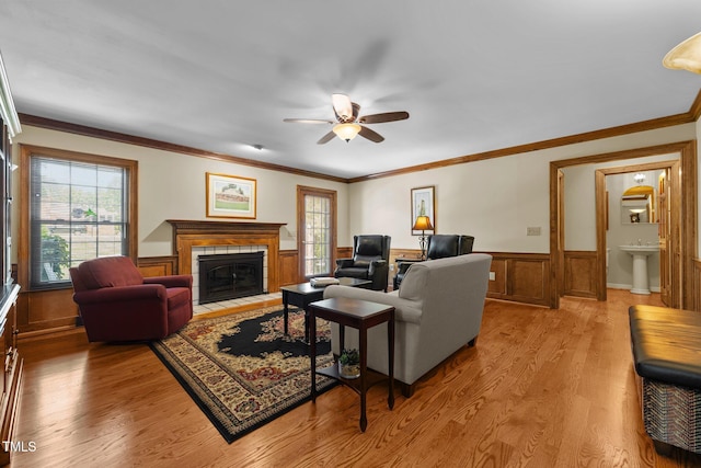 2127 Somers Ave, Burlington, NC 27215 - living room with ceiling fan, plenty of natural light, light wood-style floors, a wainscoted wall, and crown molding
