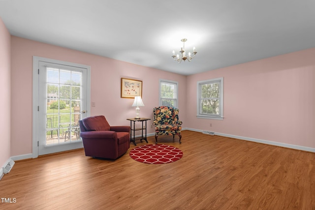 2127 Somers Ave, Burlington, NC 27215 - living area featuring a chandelier, light wood-type flooring, and baseboards