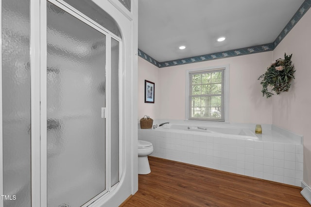 2127 Somers Ave, Burlington, NC 27215 - bathroom featuring toilet, a stall shower, a garden tub, wood finished floors, and recessed lighting