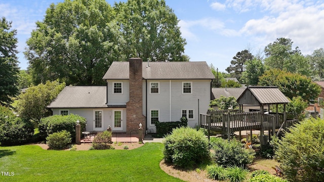 2127 Somers Ave, Burlington, NC 27215 - back of house with a yard, a wooden deck, a chimney, and a patio