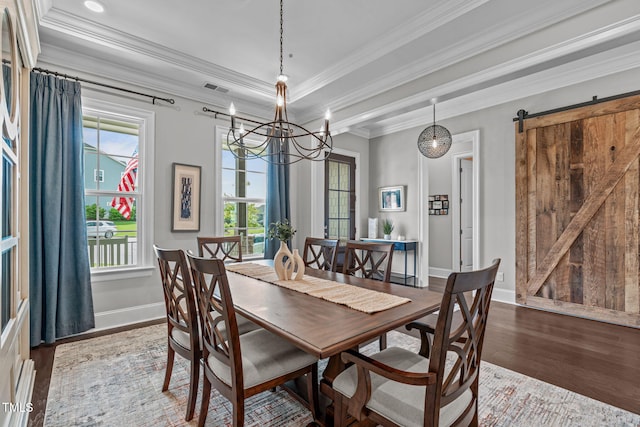 200 Baskerville Ct, Holly Springs, NC 27540 - dining space featuring wood finished floors, a chandelier, crown molding, and a barn door