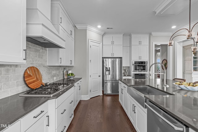 200 Baskerville Ct, Holly Springs, NC 27540 - kitchen featuring stainless steel appliances, premium range hood, crown molding, white cabinets, and dark wood-style floors