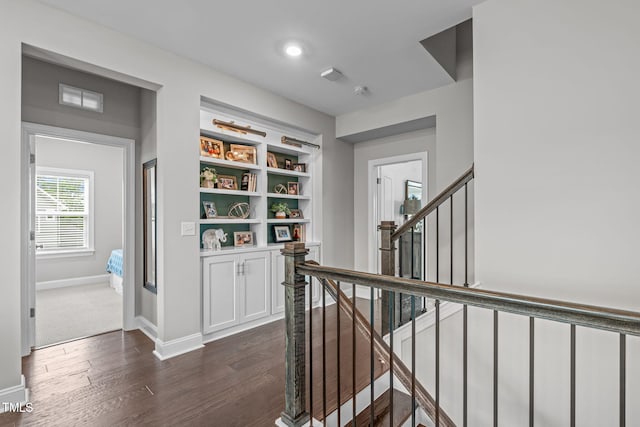 200 Baskerville Ct, Holly Springs, NC 27540 - hall featuring dark wood-style floors and an upstairs landing