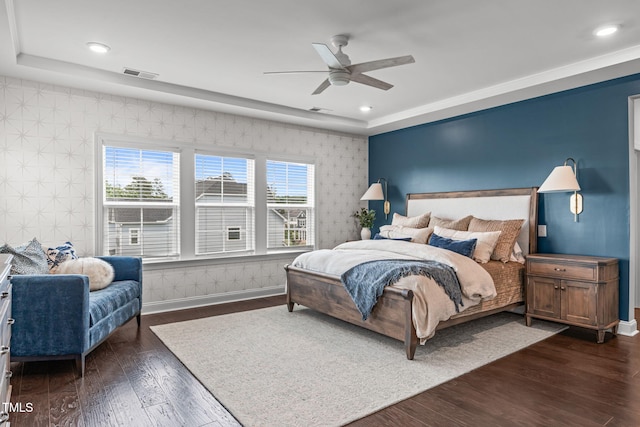 200 Baskerville Ct, Holly Springs, NC 27540 - bedroom featuring wallpapered walls, an accent wall, dark wood finished floors, a raised ceiling, and ceiling fan