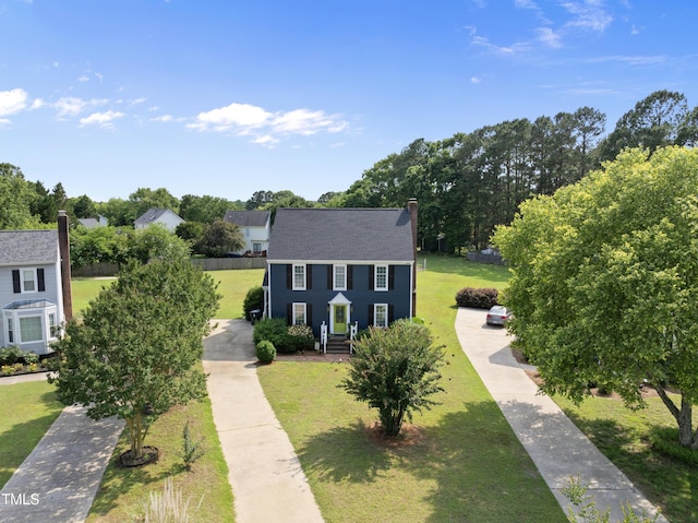 6 W Canterbury Ct, Wendell, NC 27591 - colonial home with a chimney, a front yard, and roof with shingles