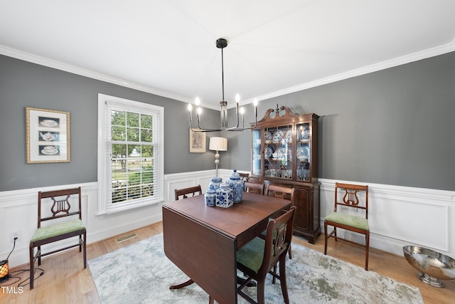 6 W Canterbury Ct, Wendell, NC 27591 - dining room with crown molding, a chandelier, wainscoting, and light wood-type flooring