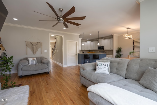 441 Heritage Village Ln, Apex, NC 27502 - living area with stairway, a ceiling fan, recessed lighting, crown molding, and light wood-style floors
