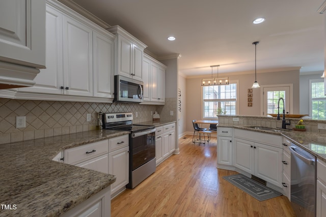 441 Heritage Village Ln, Apex, NC 27502 - kitchen with appliances with stainless steel finishes, a sink, ornamental molding, white cabinetry, and decorative backsplash