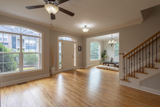 441 Heritage Village Ln, Apex, NC 27502 - foyer with baseboards, light wood-style flooring, stairway, a chandelier, and crown molding