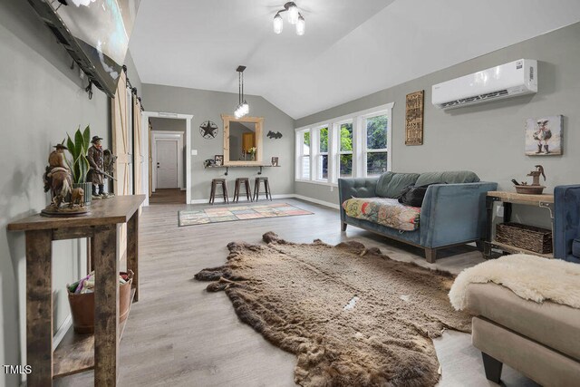 1315 Bull St, Garland, NC 28441 - living room with a wall mounted AC, wood finished floors, lofted ceiling, baseboards, and a barn door