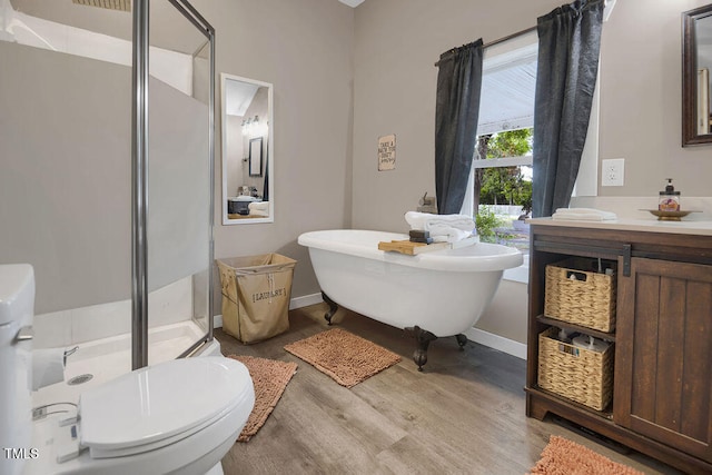 1315 Bull St, Garland, NC 28441 - bathroom with a shower stall, wood finished floors, a freestanding tub, vanity, and baseboards