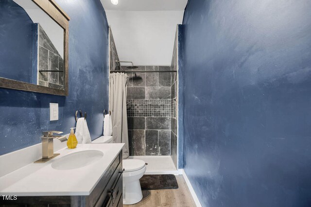 1315 Bull St, Garland, NC 28441 - full bath with toilet, a tile shower, wood finished floors, vanity, and baseboards
