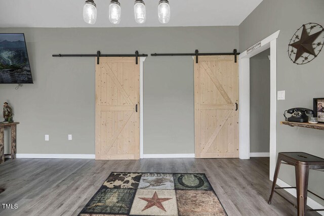 1315 Bull St, Garland, NC 28441 - foyer entrance with a barn door, wood finished floors, and baseboards