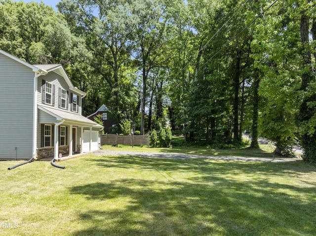 218 Mason Rd, Durham, NC 27712 - view of yard featuring a garage and view of wooded area