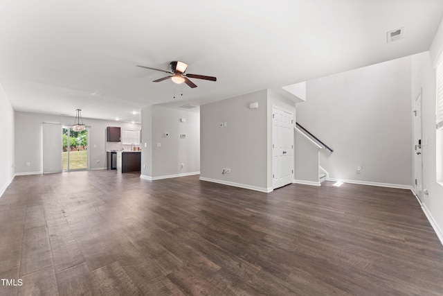 218 Mason Rd, Durham, NC 27712 - unfurnished living room with ceiling fan, baseboards, stairs, and dark wood-style flooring
