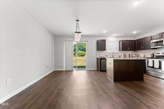 218 Mason Rd, Durham, NC 27712 - kitchen with stainless steel appliances, dark brown cabinetry, dark wood-style floors, light countertops, and decorative backsplash