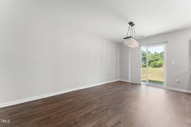 218 Mason Rd, Durham, NC 27712 - spare room featuring dark wood-type flooring, baseboards, and a chandelier