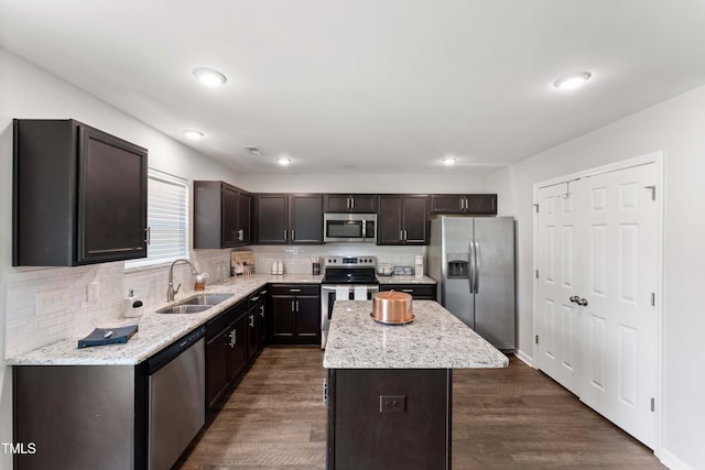 218 Mason Rd, Durham, NC 27712 - kitchen with appliances with stainless steel finishes, a sink, a kitchen island, backsplash, and recessed lighting