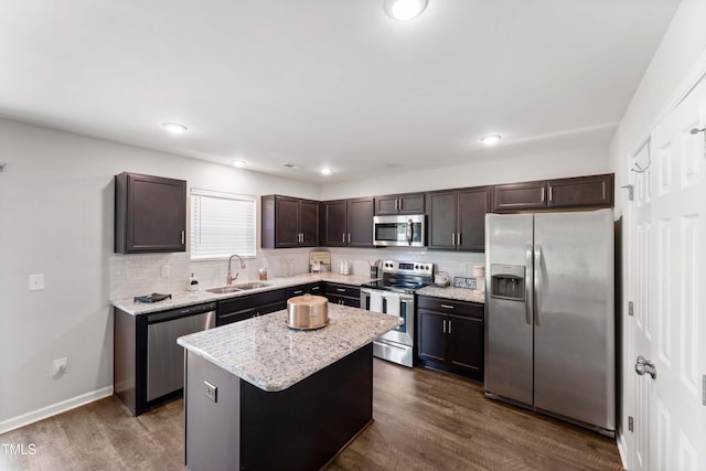 218 Mason Rd, Durham, NC 27712 - kitchen featuring appliances with stainless steel finishes, a sink, dark brown cabinets, tasteful backsplash, and recessed lighting