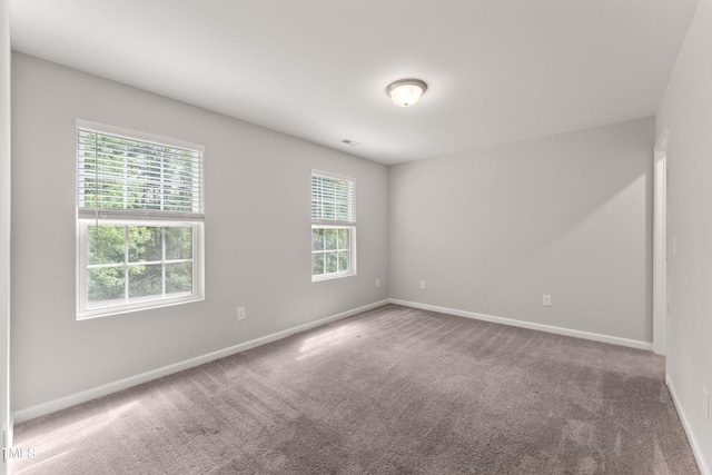 218 Mason Rd, Durham, NC 27712 - empty room with baseboards and carpet floors