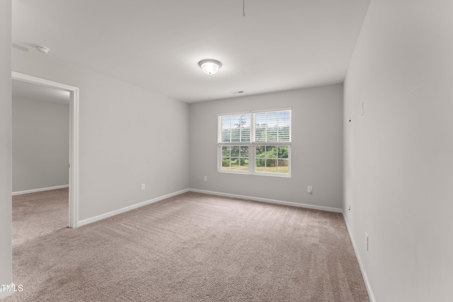 218 Mason Rd, Durham, NC 27712 - carpeted empty room featuring baseboards and a smoke detector