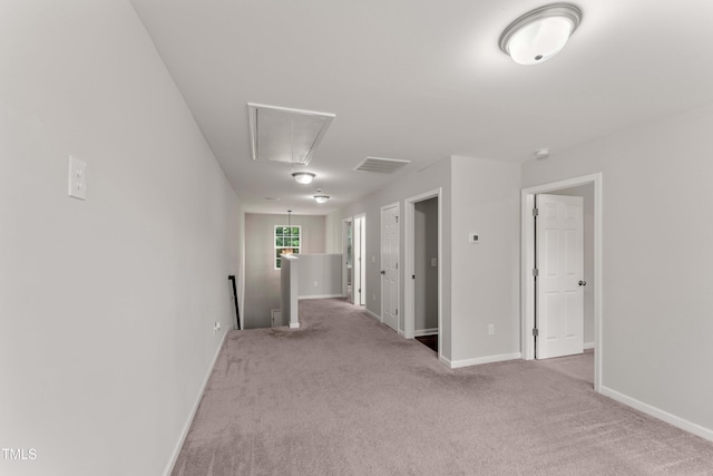 218 Mason Rd, Durham, NC 27712 - carpeted spare room featuring attic access and baseboards
