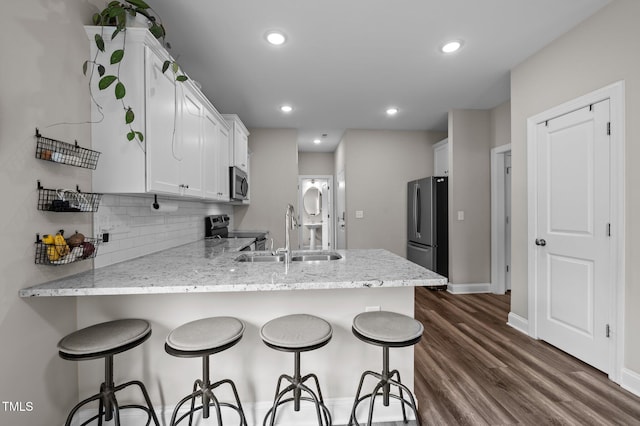 412 Carr Store Rd, Cedar Grove, NC 27231 - kitchen with appliances with stainless steel finishes, a sink, a peninsula, white cabinets, and dark wood finished floors
